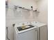 Laundry room with washer, dryer, and shelving at 1833 Ross Hammock Ave, Groveland, FL 34736
