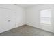 Simple bedroom with double door closet and carpet flooring at 1833 Ross Hammock Ave, Groveland, FL 34736