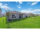 Spacious backyard with covered patio and grassy area at 1833 Ross Hammock Ave, Groveland, FL 34736