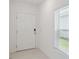 Bright entryway with white door and window blinds at 1833 Ross Hammock Ave, Groveland, FL 34736