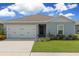 House exterior featuring a two-car garage and well-maintained lawn at 162 Piave St, Haines City, FL 33844
