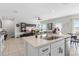 Open kitchen island with breakfast bar and view of the living room at 162 Piave St, Haines City, FL 33844
