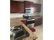 Kitchen with dark wood cabinets, granite countertops, and stainless steel appliances at , Lake Mary, FL 32746