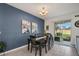 Bright dining area with dark wood table, six chairs, and access to backyard at 15259 Willow Arbor Cir, Orlando, FL 32824