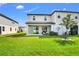 Private backyard with covered patio, spacious lawn area and a tree at 15259 Willow Arbor Cir, Orlando, FL 32824