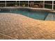 Inviting freeform pool with a spacious brick patio at 8208 Vineland Oaks Blvd, Orlando, FL 32835
