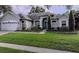 Two story home with attached garage and manicured lawn at 8208 Vineland Oaks Blvd, Orlando, FL 32835