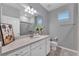 Bathroom with gray vanity, quartz countertop, and walk-in shower at 2210 Lelani Cir, Davenport, FL 33897