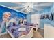 Charming Frozen-themed bedroom with two twin beds and mural at 2210 Lelani Cir, Davenport, FL 33897