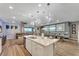 Modern kitchen with white cabinets, large island, and quartz countertops at 2210 Lelani Cir, Davenport, FL 33897