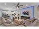 Open living room with modern furniture, kitchen island, and large TV at 2210 Lelani Cir, Davenport, FL 33897