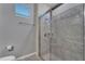 Walk-in shower with gray tile and glass enclosure at 2210 Lelani Cir, Davenport, FL 33897