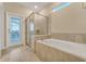 Soaking tub and separate shower with access to the backyard pool at 2210 Lelani Cir, Davenport, FL 33897