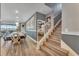 Modern staircase with wood steps and white railing in a spacious home at 2210 Lelani Cir, Davenport, FL 33897