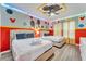 Mickey Mouse themed bedroom with two twin beds and colorful decor at 2210 Lelani Cir, Davenport, FL 33897