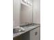 Bathroom with granite countertop, white cabinets, and a large mirror at 18645 Seaview St, Orlando, FL 32833