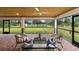 Spacious screened patio with seating area and view of backyard at 18645 Seaview St, Orlando, FL 32833