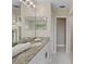 Bathroom with double vanity, granite countertop, and a walk-in shower at 18645 Seaview St, Orlando, FL 32833