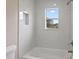 Bathroom with marble tile, a bathtub and window at 18645 Seaview St, Orlando, FL 32833