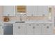 Kitchen with white cabinets, quartz countertops, and herringbone backsplash at 18645 Seaview St, Orlando, FL 32833