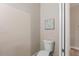 Small toilet and wall-mounted artwork in a simple bathroom at 18645 Seaview St, Orlando, FL 32833