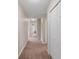 Hallway with carpeted floors and access to multiple rooms at 18645 Seaview St, Orlando, FL 32833
