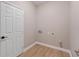 Laundry room with white door and light wood flooring at 18645 Seaview St, Orlando, FL 32833