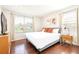 Bright bedroom with king-size bed and hardwood floors at 290 Las Fuentes Dr, Kissimmee, FL 34746
