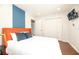 Bright bedroom with orange headboard and ample closet space at 290 Las Fuentes Dr, Kissimmee, FL 34746
