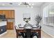 Spacious dining area with wood table and black metal chairs, bathed in natural light at 290 Las Fuentes Dr, Kissimmee, FL 34746