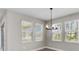 Bright dining area with three windows and stylish light fixture at 2141 Divot Drive Dr, Daytona Beach, FL 32124