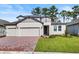Two-story house with a three-car garage and a brick driveway at 2141 Divot Drive Dr, Daytona Beach, FL 32124