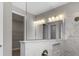 Elegant bathroom with marble tile, double vanity, and large mirror at 2141 Divot Drive Dr, Daytona Beach, FL 32124