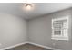 Simple bedroom with a window and neutral walls at 2141 Divot Drive Dr, Daytona Beach, FL 32124