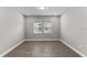 Well-lit bedroom with neutral walls and wood-look tile flooring at 2141 Divot Drive Dr, Daytona Beach, FL 32124
