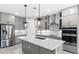 Modern kitchen with gray cabinets, stainless steel appliances, and an island at 2153 Divot Dr, Daytona Beach, FL 32124