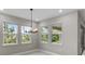 Bright dining room with large windows and a modern chandelier at 2153 Divot Dr, Daytona Beach, FL 32124