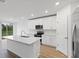 Modern kitchen with island, stainless steel appliances, and white cabinets at 3182 Viceroy Ct, Poinciana, FL 34759