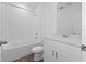 Bright bathroom featuring a white vanity, shower, and toilet at 3182 Viceroy Ct, Poinciana, FL 34759