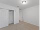 Simple bedroom with carpeted floor, closet, and door at 3182 Viceroy Ct, Poinciana, FL 34759