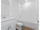 Clean bathroom with white vanity, bathtub, and tile floor at 3182 Viceroy Ct, Poinciana, FL 34759