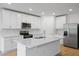Modern kitchen with white cabinets and quartz countertops at 3182 Viceroy Ct, Poinciana, FL 34759
