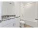 Bathroom with granite countertop, white cabinets, and a shower/tub combo at 3174 Viceroy Ct, Poinciana, FL 34759