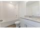 Clean bathroom with granite countertop, white cabinets, and a shower/tub combo at 3174 Viceroy Ct, Poinciana, FL 34759
