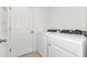 Laundry room with washer, dryer, and ample storage at 3793 Bluethread Way, Poinciana, FL 34759