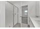 Modern bathroom with a walk-in shower and access to bedroom at 3793 Bluethread Way, Poinciana, FL 34759