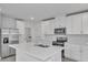 Modern kitchen with white cabinets and center island at 3793 Bluethread Way, Poinciana, FL 34759