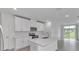 Modern kitchen with white cabinets and stainless steel appliances at 3793 Bluethread Way, Poinciana, FL 34759