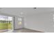 Spacious living room with sliding glass doors and view of backyard at 3793 Bluethread Way, Poinciana, FL 34759
