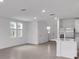 Open living room with tile floors and access to kitchen at 3793 Bluethread Way, Poinciana, FL 34759